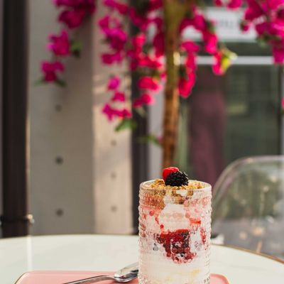 Healthy yogurt parfait topped with fresh berries, granola and a drizzle of honey served at La Vie Belle Miami