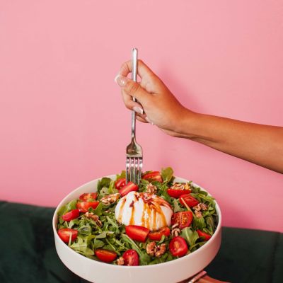 Close-up of La Vie Belle’s fresh Italian salad with creamy burrata, cherry tomatoes, arugula and olive oil