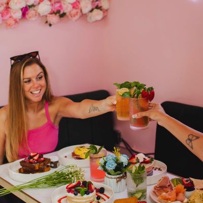 Brunch table with pancakes, fresh juice and French toast under the flower dome at La Vie Belle Miami Beach